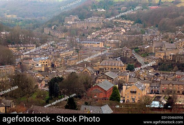 panoramic view of the town of hebden bridge showing the main roads, houses and streets with mill chimneys in winter