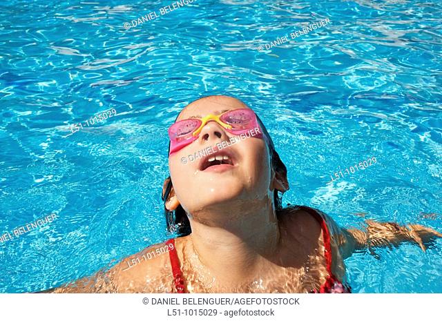 Girl with goggles on a swimming pool in Ludiente, Castellón