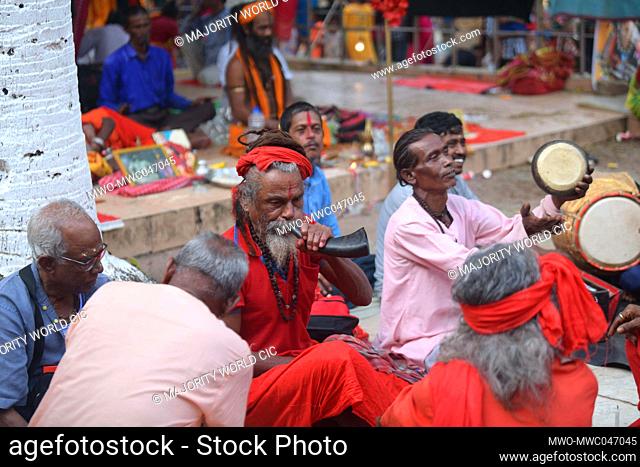 A Hindu Holy man blows a buffalo horn during a three day long traditional Brahmakund mela festival in Brahmakund. Agartala. India