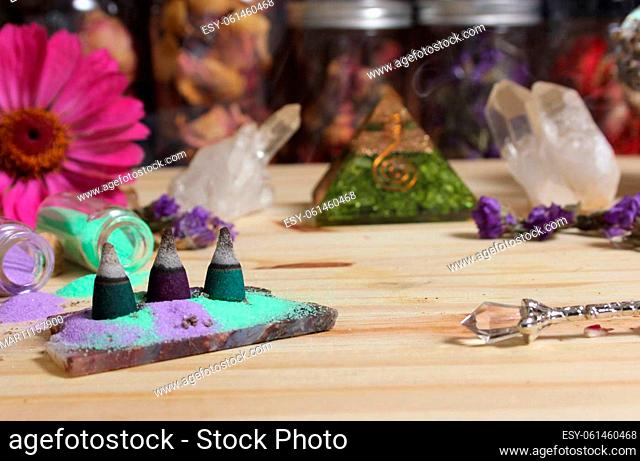 Incense Cones on Stone Slab With Chakra Crystals and Flowers