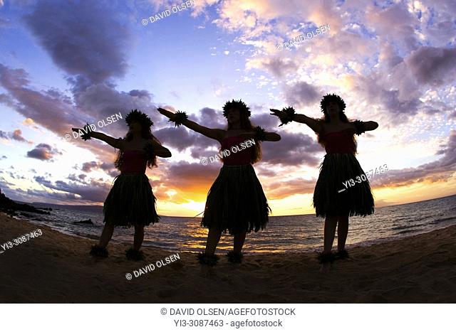 Three hula dancers at sunset, Maui, Hawaii