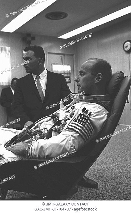 Astronaut Charles Conrad Jr., Gemini-5 pilot, is pictured during suiting up operations on the morning of the flight of Gemini-5. With him is Dr