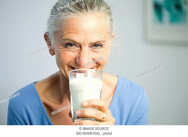 Mature woman drinking milk