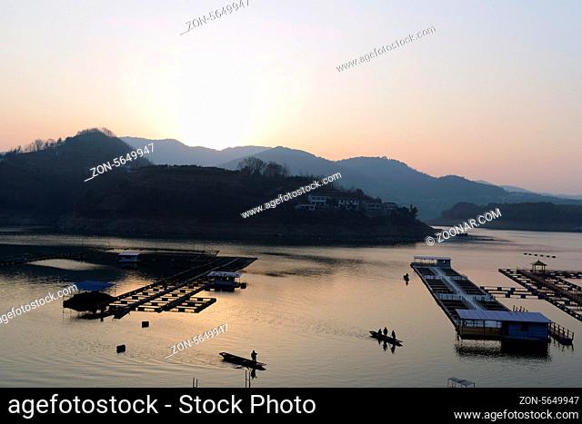 Landscape of sunset on a lake with boats