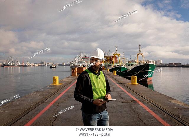 Dock worker using digital tablet