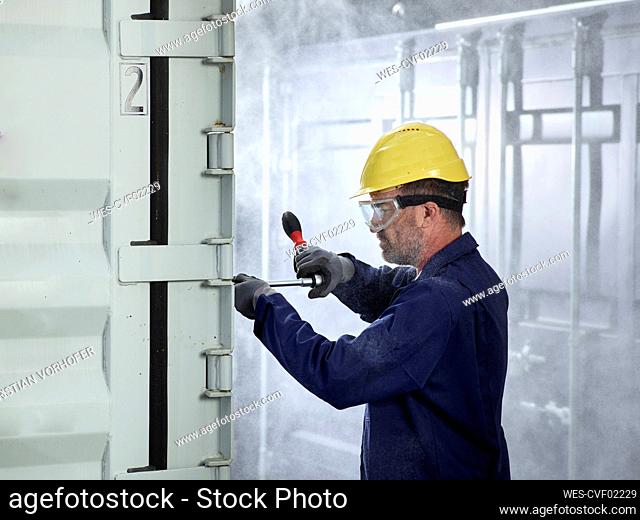 Industrial worker fixing cargo container