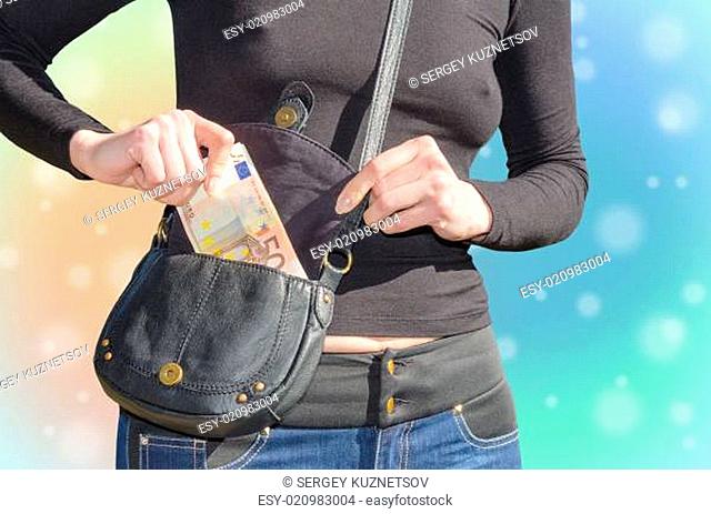 Sexy woman puts a bundle of cash in your purse