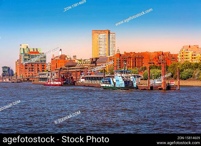 Hamburg, Germany - July 26, 2018: City skyline view of Elbe river with harbor, market and modern red houses