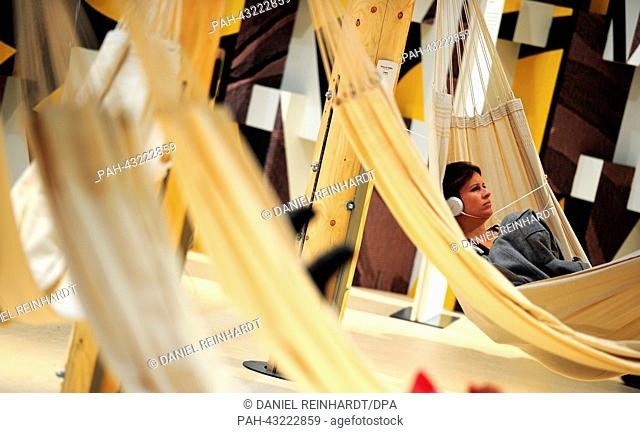A woman lies in a hammock at the exhibition pavilion of Brazil at the Frankfurt Book Fair in Frankfurt Main, Germany, 08 October 2013