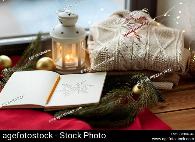 sketchbook, christmas lantern, sweater, fir branch