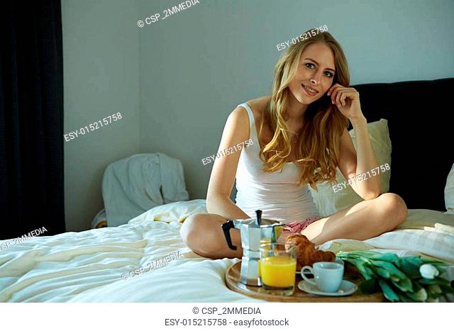 Young beautiful woman having breakfast