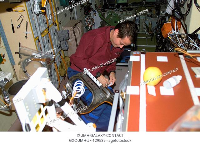 Astronaut Daniel W. Bursch, Expedition Four flight engineer, works with equipment in the Zvezda Service Module on the International Space Station (ISS)