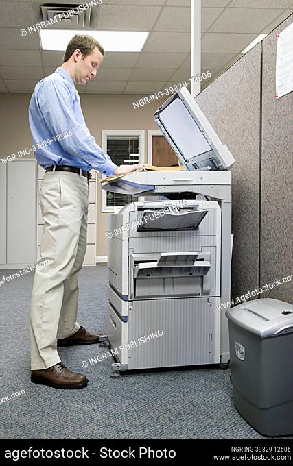 Office worker photocopying