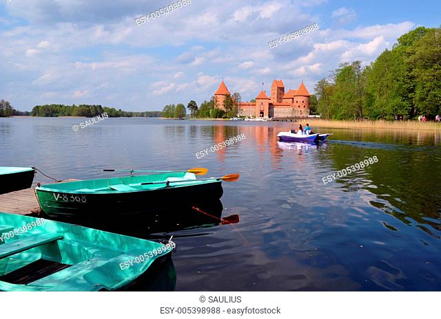 Boats on Galve lake shore and Trakai Castle