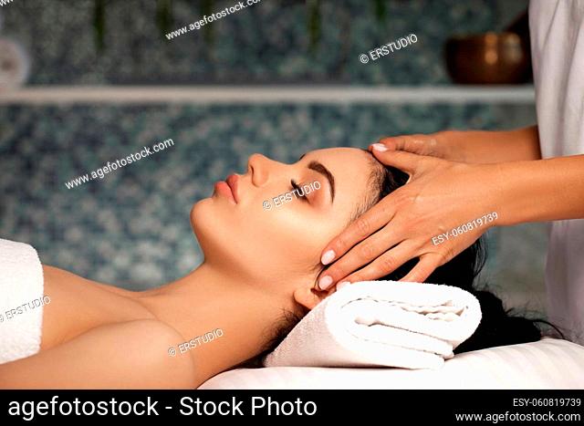 anti-aging facial massage. Woman receiving massage from masseur at Spa salon