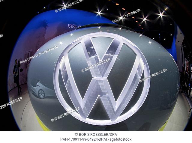 The VW logo of the concept study ""VWÂ IDÂ Buzz"" glows on the grounds of the fair in Frankfurt/Main, Germany, 11 September 2017