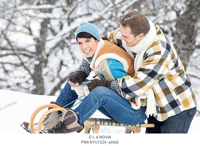 Young couple embracing on sled