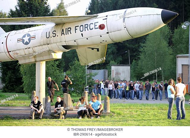 Under a rocket sitting visitors of the Nature one- techno party near Kastellaun , Rhineland-Palatinate, Germany, where former the us-Army were stationed