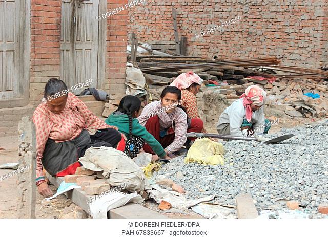 Women rebuild destroyed buildings in Bhaktapur, Nepal, 31 March 2016. Many people in rural regions have no funds for the reconstruction of their homes in stark...