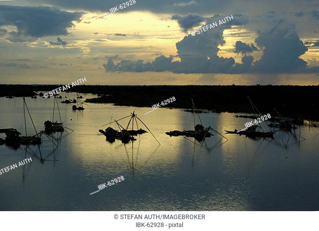 Fishing boats on the Mekong with evening sky Kompong Cham Cambodia