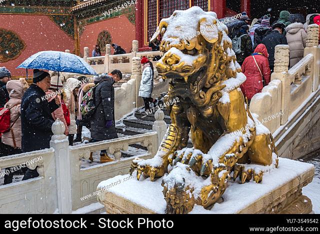 Gilded Chinese lion sculptures in front of Gate of Heavenly Purity in Forbidden City palace complex in central Beijing, China