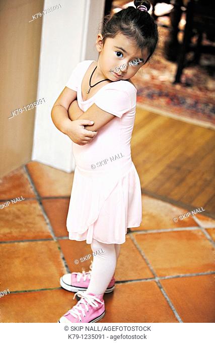 Little girl in ballet costume looking at camera