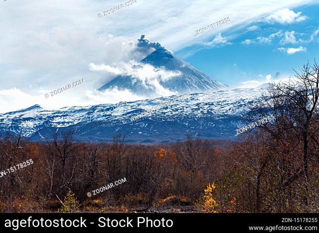 Volcanic landscape of Kamchatka: active Klyuchevskoy Volcano, view of volcanic eruption - plume of gas, steam and ash from crater