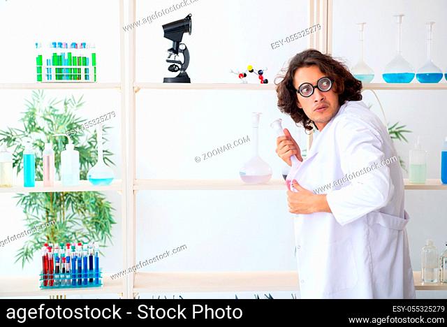 The funny male chemist working in the lab