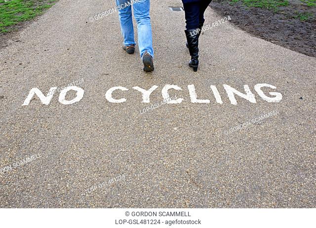 People walking past a No Cycling sign