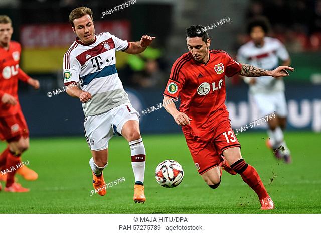 Munich's Mario Goetze and Leverkusen's Roberto Hilbert in action during the German DFB Cup quarter final soccer match between Bayer Leverkusen and Bayern Munich...