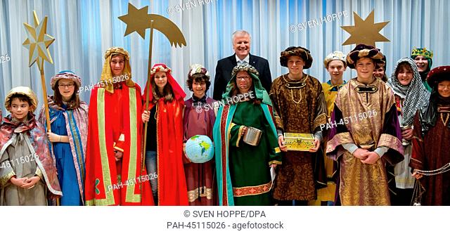 Premier of Bavaria, Horst Seehofer (CSU), poses with carol singers for a group photo at the state chancellery in Munich, Germany, 30 December 2013