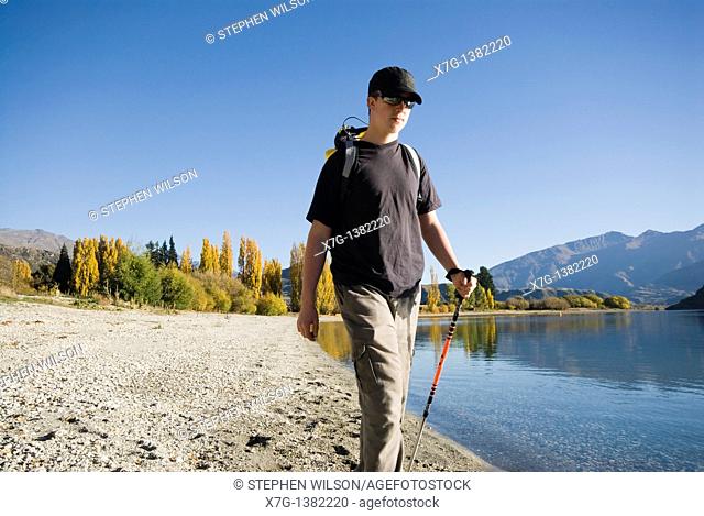 Young hiker walking at Glendhu Bay on the shores of Lake Wanaka, South Island of New Zealand