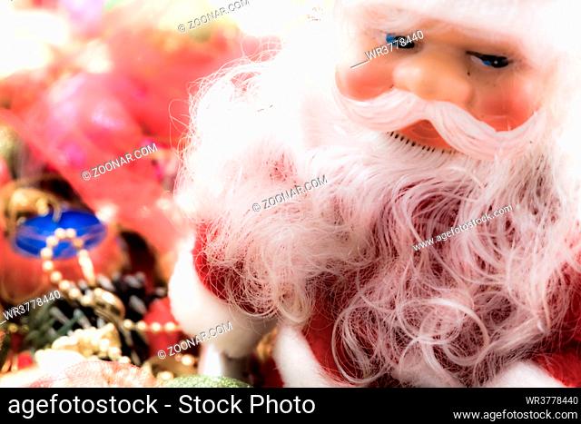 Santa in a Christmas vibrant colorful wallpaper background texture of balls and decorations for the celebration tree