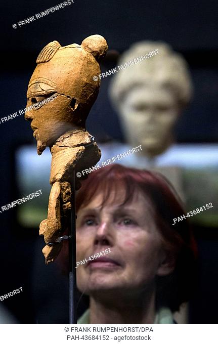 A visitor looks at a terracotta head (800-400 BC) during the preview of the exhibition 'Nok. An origin of African sculpture' at the Liebieghaus in Frankfurt am...