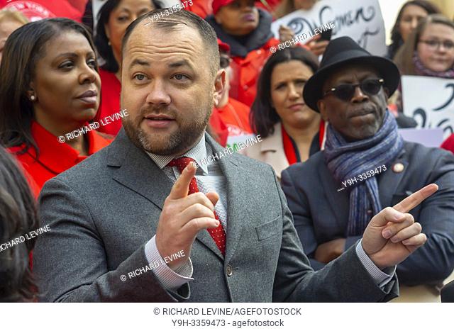 NYC Council Speaker Corey Johnson joins activists, community leaders, union members and other politicians on the steps of City Hall in New York on Tuesday