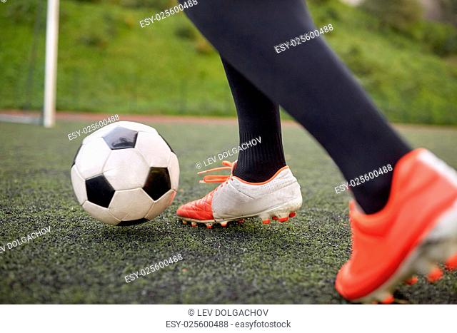 sport, football and people - soccer player playing with ball on field