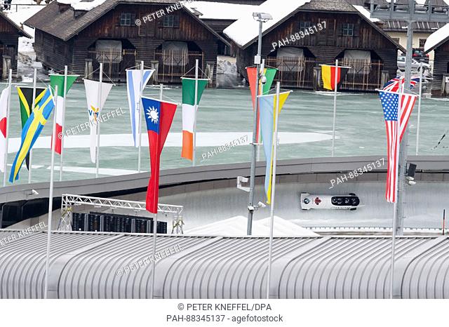 The four-person Bob with Nick Poloniato, Daniel Sunderland, Derek Plug and Keenan Macdougall from Canada passing the echo-curve lined with flags in Schoenau Am...
