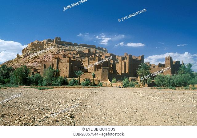 Kasbah famous for appearing in films such as Jesus of Nazareth and Lawrence of Arabia. Exterior walls with small group of people in foreground