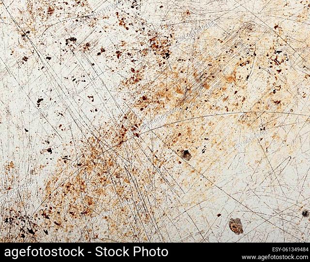 Close up grunge abstract uneven background of vintage weathered surface with defects, stains and scratches