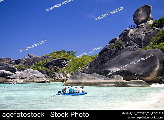 Visitors are ferried ashore below large granite rock at white sand beach Similan Island Ko 8 Similan Islands Thailand