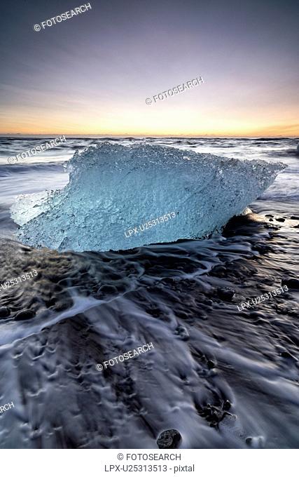 Iceberg on beach at sunrise, Jokulsarlon, Iceland