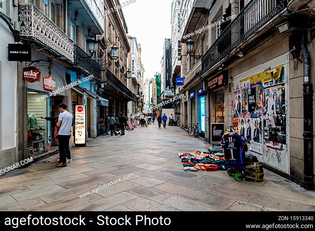 Corunna, Spain - July 20, 2020: View of migrant street vendors in pedestrian shopping street in city centre