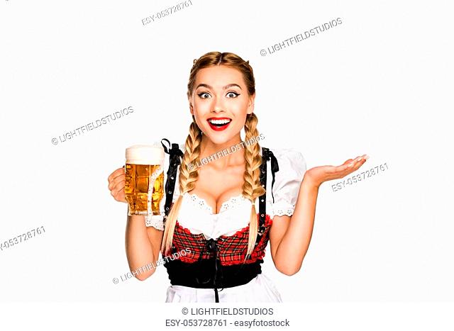 excited waitress in traditional german costume holding beer glass on Oktoberfest, isolated on white