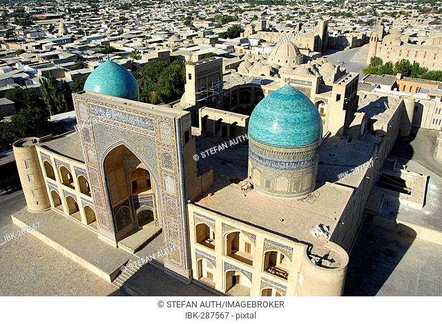 View over the blue cupolas of Mir-i Arab Madrasah and roofs of the city from minaret Kalon Bukhara Uzbekistan