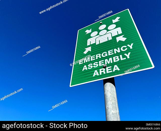 Emergency assembly are sign against blue sky