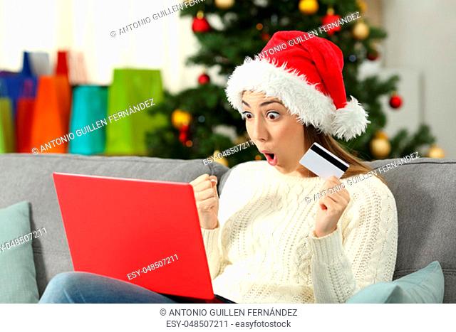 Amazed woman buying gifts on line in christmas