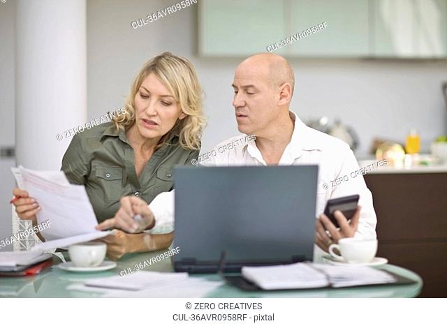 Couple paying their bills at home