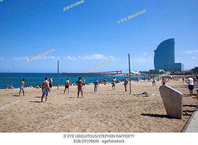 Playa de St Sebastia, Barceloneta Beach, people playing volleyball with the W hotel behind