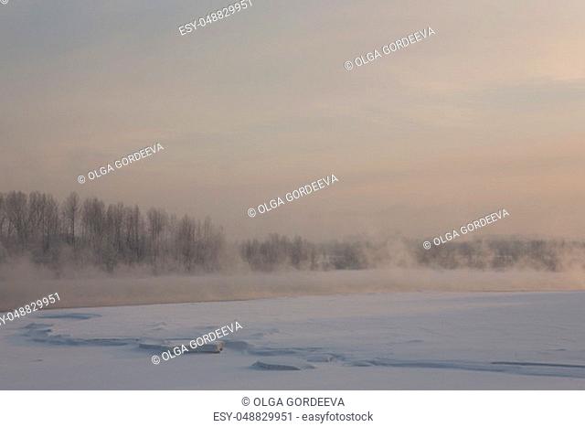 winter frosty sunset on the river in Siberia in winter in December
