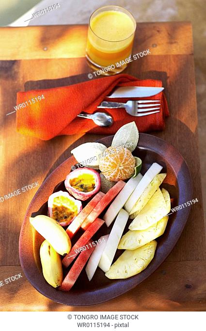 plates with fruits and juice